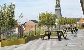 Roof terrace with two round picnic tables