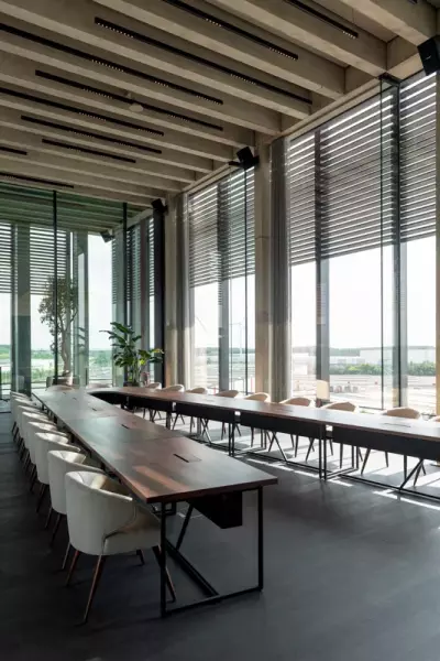 Meeting room H.Essers Large v-shaped wooden conference table with modern conference chairs